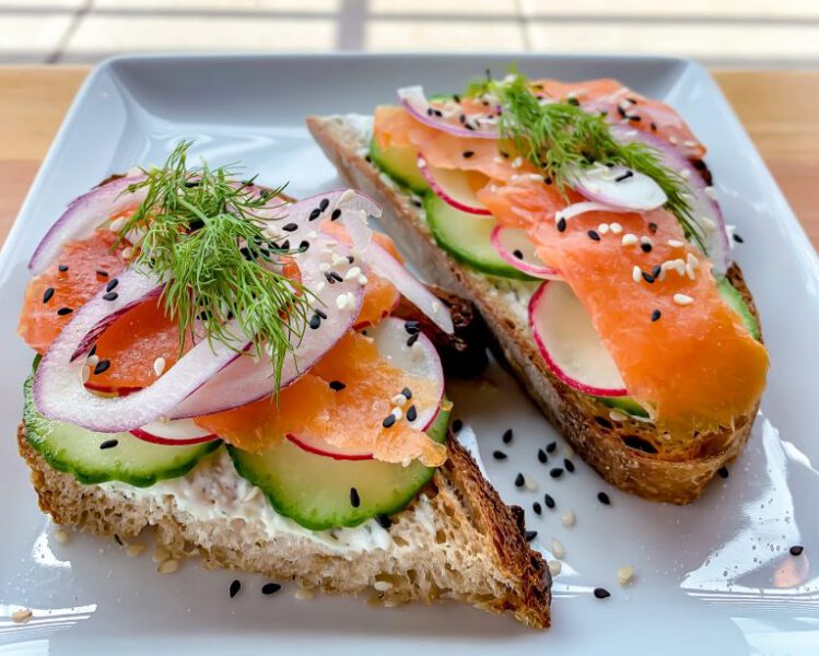 Freshly baked bread toasted topped with creme fraiche, cucumber, sliced red onion, lox, topped with fresh dill.