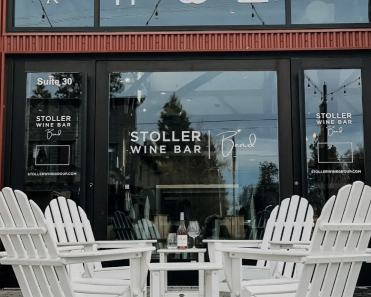 Stoller wine bar patio with outdoor seating in white adirondack chairs