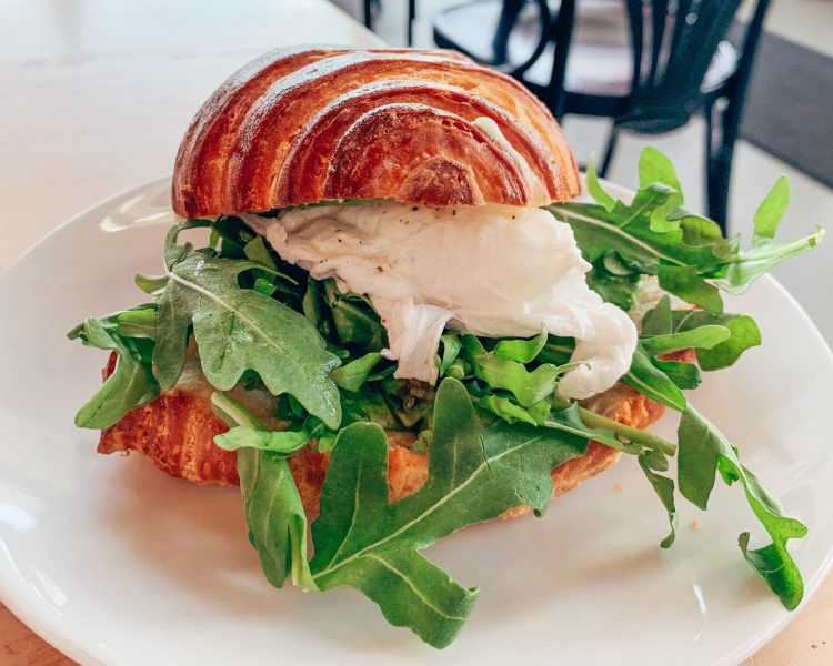 Hand-rolled croissant filled with poached egg, fresh arugula, and bright green aioli.