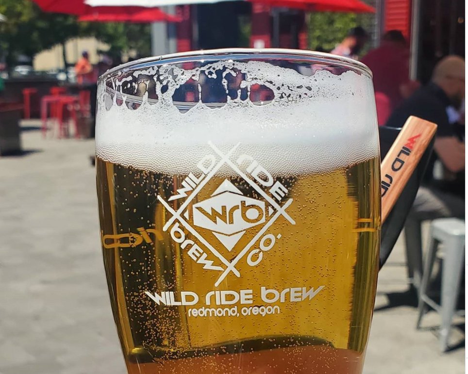 Close up lagel beer with the Wild Ride brewing logo on glass