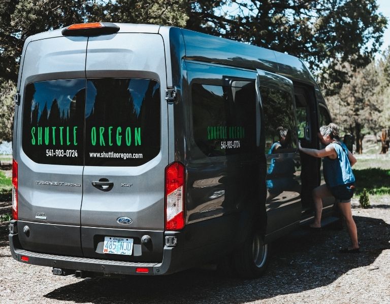 Woman steps into a Shuttle outside of a winery in Central Oregon