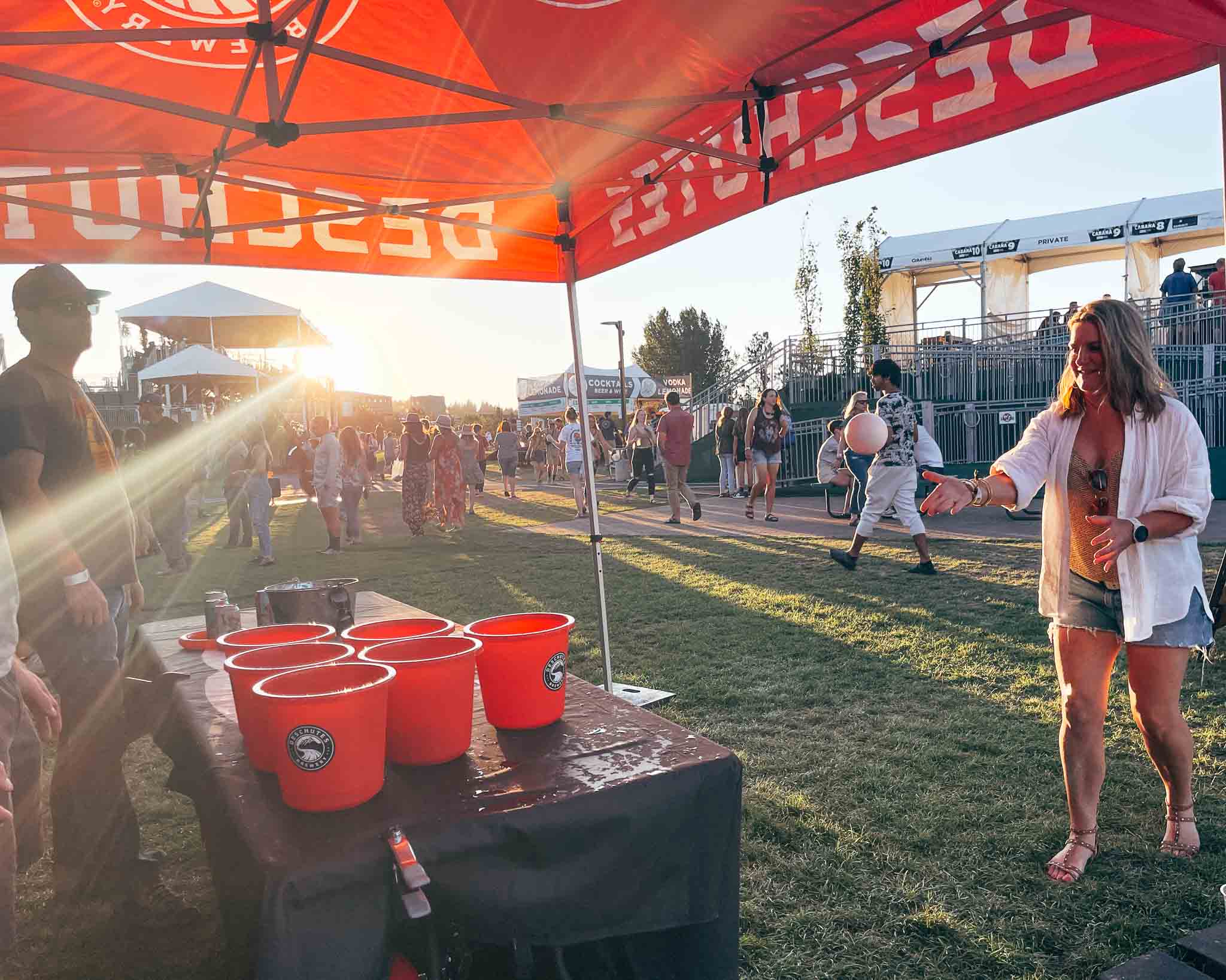 Woman tosses a ball into a bucket of water at the Bend concerts in Oregon