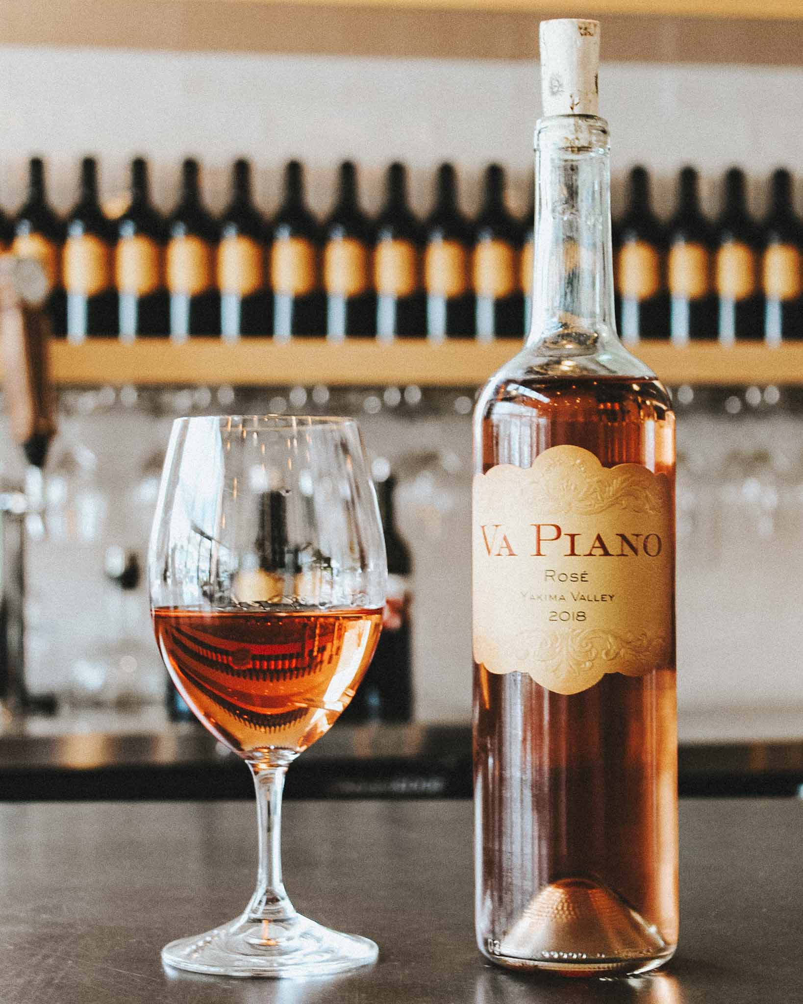 glass of rosé sits next to a bottle of va piano vineyards wine