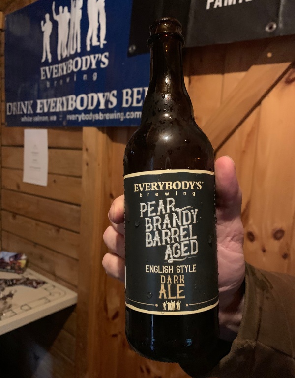hand holds a bottle of English style dark ale at suttle lodge winter beer fest