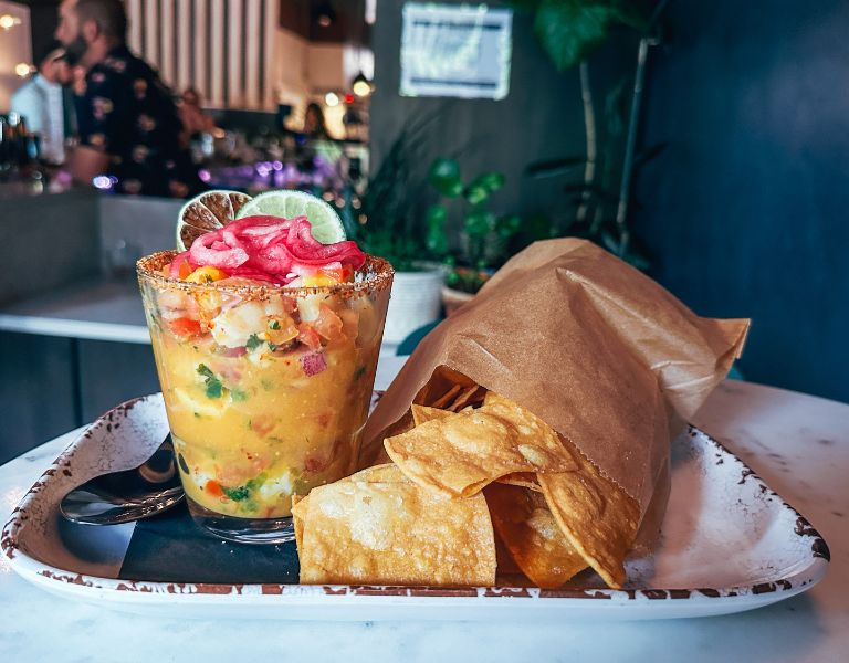 bright orange ceviche paired with a bag of tortilla chips