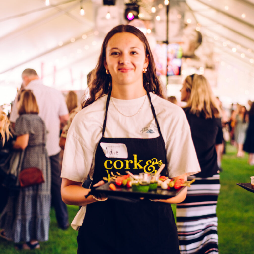 woman serves appetizers at cork and barrel in Bend