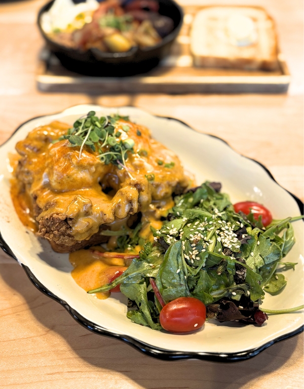 plate of fried chicken benedict and sesame side salad