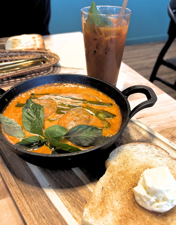 small skillet with thai curry baked eggs