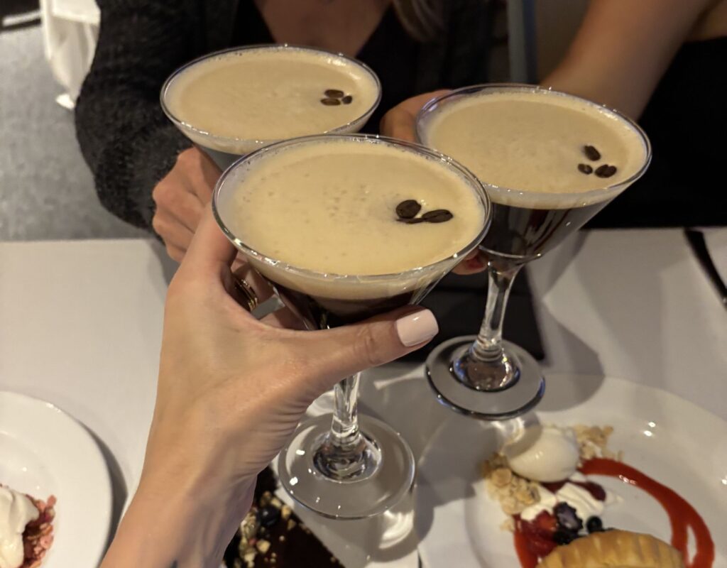 three people cheers a round of espresso martinis