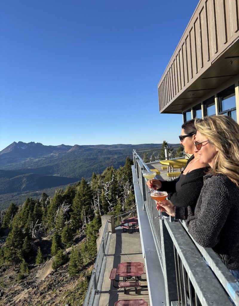 two women look out from the view of pine marten lodge